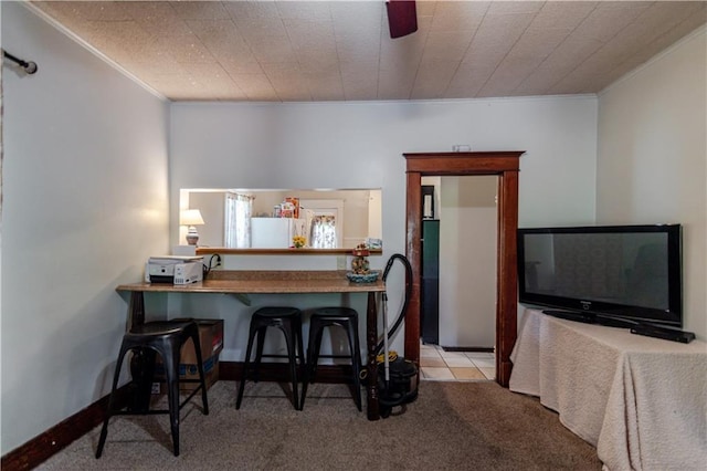 911 N 6th St, Atchison, KS 66002 - kitchen with crown molding, carpet floors, freestanding refrigerator, and a breakfast bar