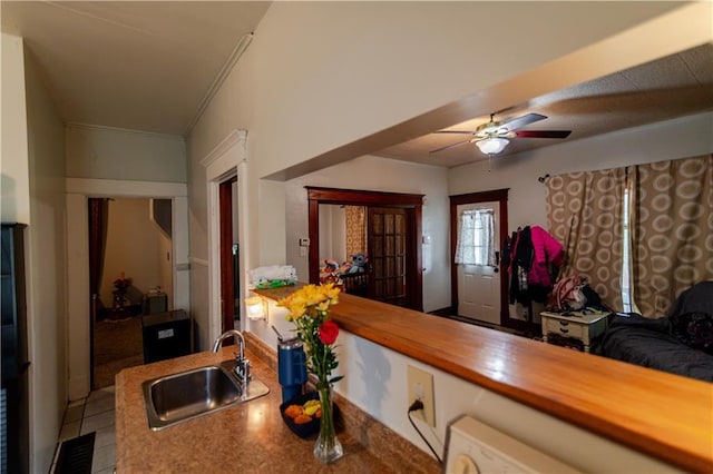 911 N 6th St, Atchison, KS 66002 - kitchen with a sink, a ceiling fan, wood counters, tile patterned flooring, and ornamental molding