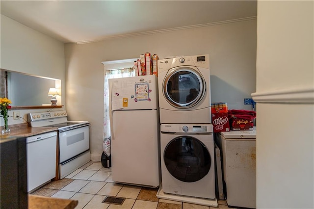 911 N 6th St, Atchison, KS 66002 - washroom featuring stacked washer / dryer and light tile patterned floors