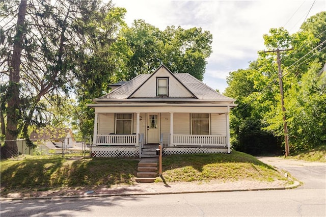 911 N 6th St, Atchison, KS 66002 - bungalow-style house with a porch, fence, and roof with shingles