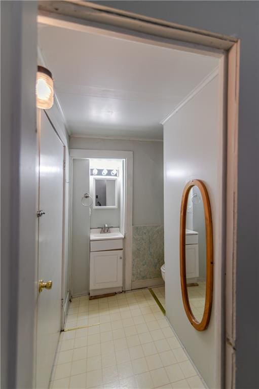 911 N 6th St, Atchison, KS 66002 - bathroom with vanity, toilet, and ornamental molding