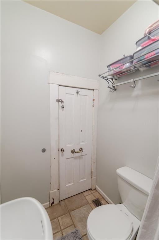 911 N 6th St, Atchison, KS 66002 - bathroom featuring toilet and baseboards