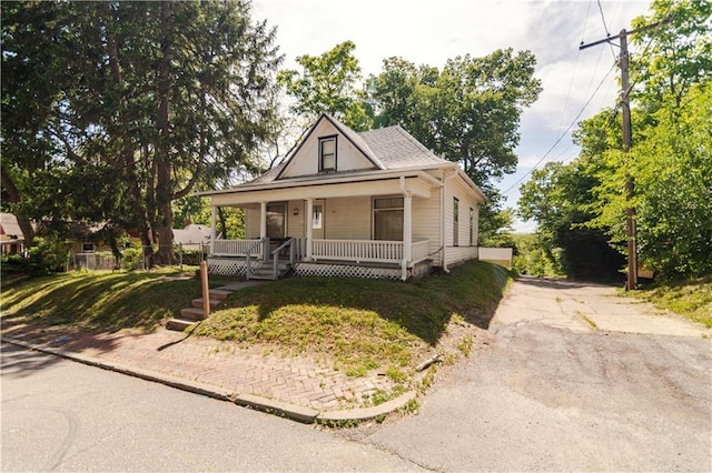 911 N 6th St, Atchison, KS 66002 - view of front of house featuring covered porch and driveway