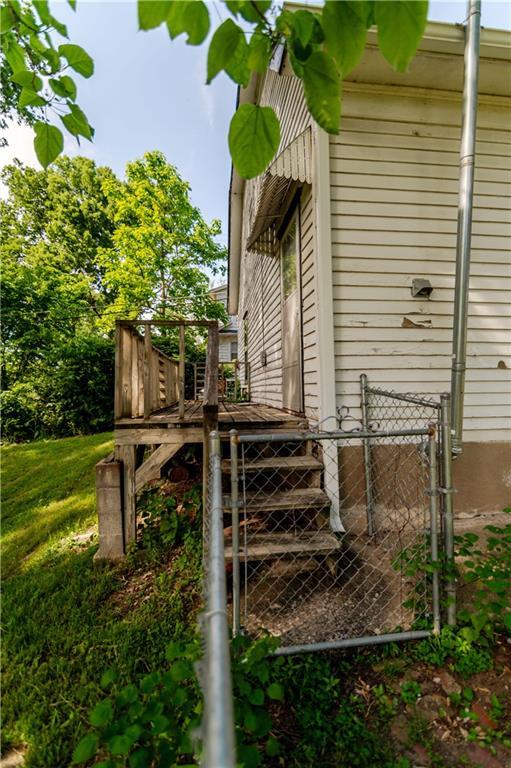 911 N 6th St, Atchison, KS 66002 - view of side of property with a gate and fence