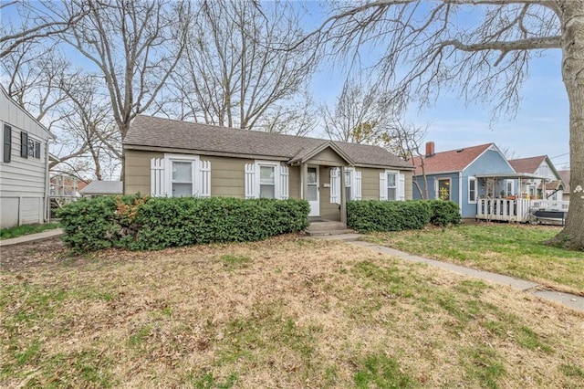 ranch-style house featuring a front lawn