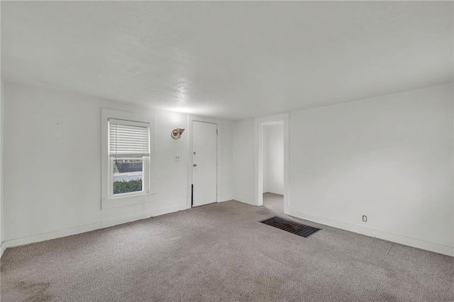 carpeted spare room with baseboards