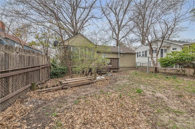 view of yard with fence and a deck