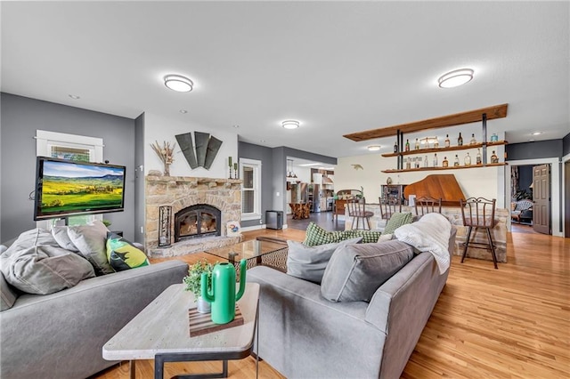 11261 238th St, Lawrence, KS 66044 - living area featuring light wood-style flooring and a stone fireplace