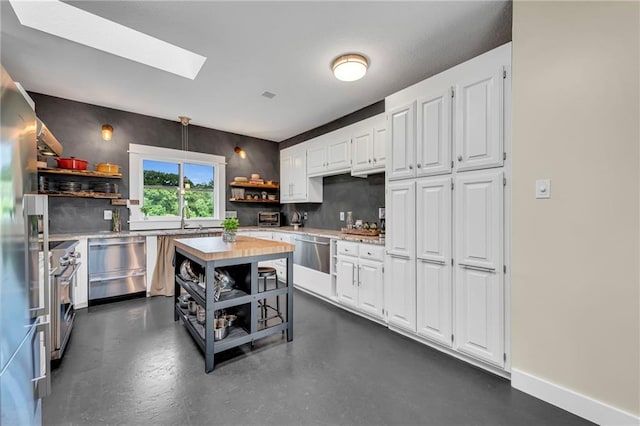 11261 238th St, Lawrence, KS 66044 - kitchen featuring open shelves, stainless steel appliances, white cabinets, light countertops, and a skylight