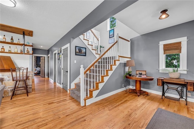 11261 238th St, Lawrence, KS 66044 - stairs featuring wood finished floors, plenty of natural light, and baseboards