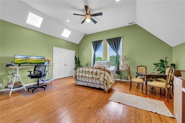 11261 238th St, Lawrence, KS 66044 - bedroom featuring a skylight, vaulted ceiling, wood finished floors, a closet, and ceiling fan