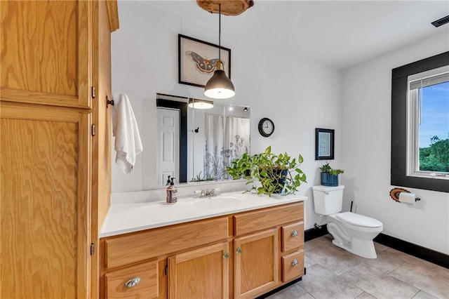 11261 238th St, Lawrence, KS 66044 - bathroom with toilet, vanity, tile patterned flooring, and baseboards