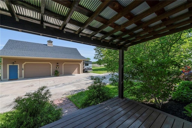 11261 238th St, Lawrence, KS 66044 - deck with driveway and a garage