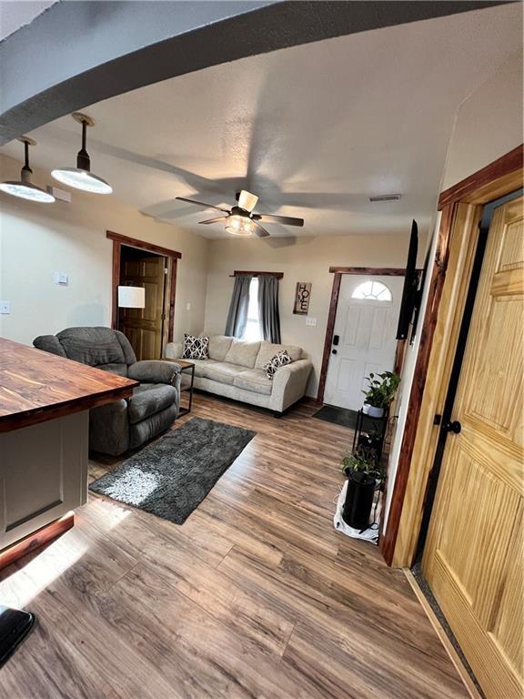 702 N Cedar St, Nevada, MO 64772 - living room featuring wood finished floors and a ceiling fan