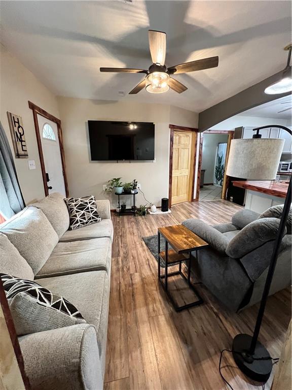 702 N Cedar St, Nevada, MO 64772 - living room with ceiling fan and wood finished floors
