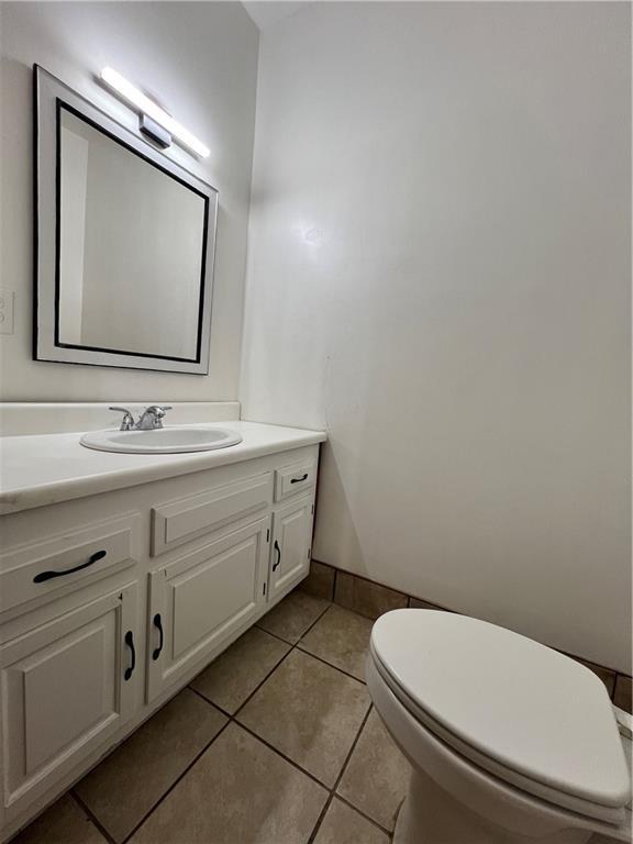 702 N Cedar St, Nevada, MO 64772 - half bath with vanity and tile patterned flooring