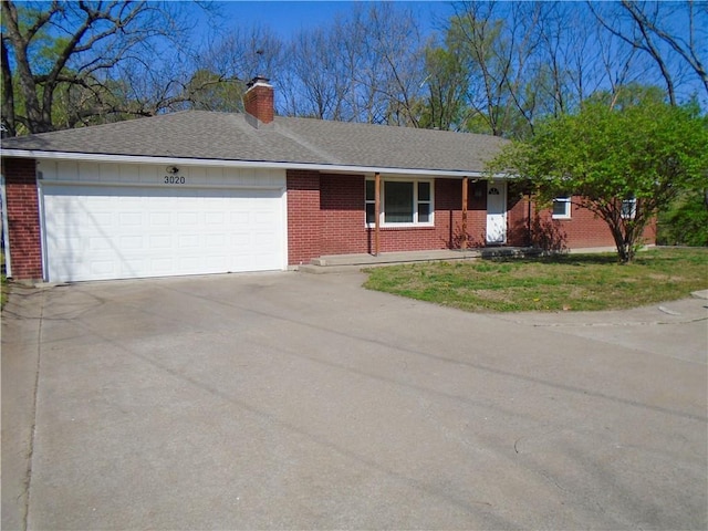 3020 N 81st St, Kansas City, KS 66109 - single story home featuring brick siding, a garage, concrete driveway, and a chimney