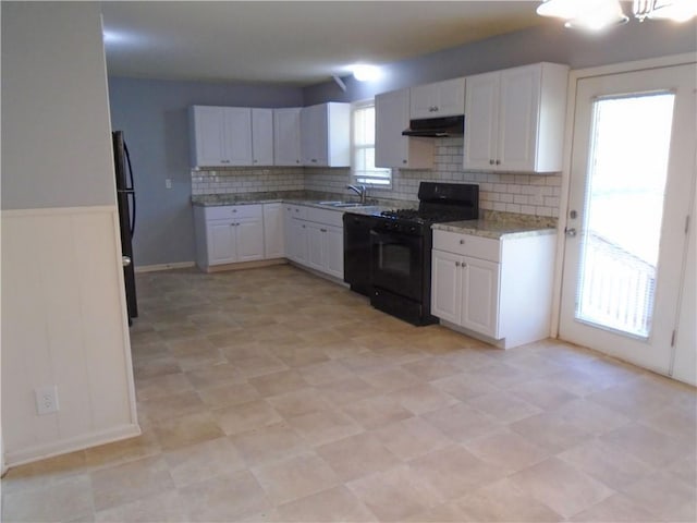 3020 N 81st St, Kansas City, KS 66109 - kitchen featuring black appliances, under cabinet range hood, white cabinetry, tasteful backsplash, and a sink