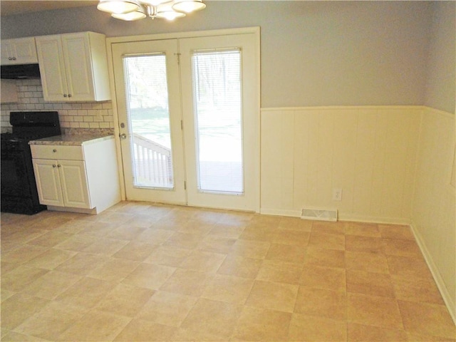 3020 N 81st St, Kansas City, KS 66109 - unfurnished dining area featuring plenty of natural light, wainscoting, and a chandelier