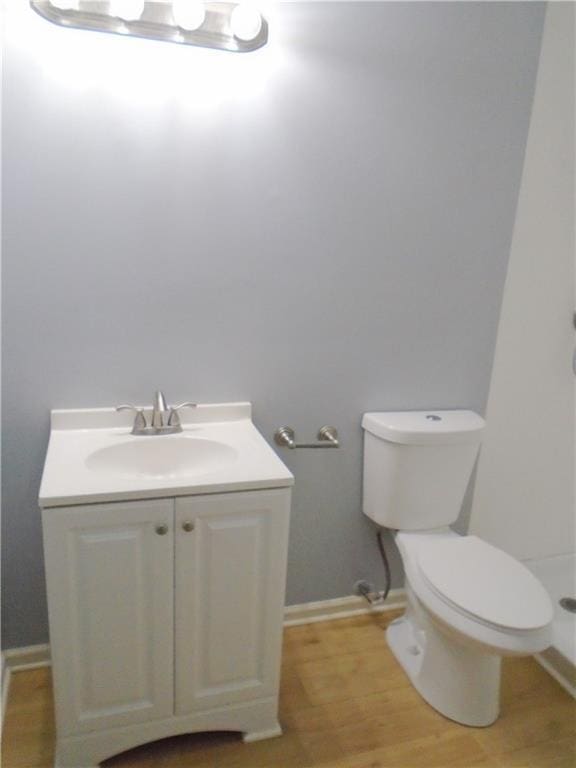 3020 N 81st St, Kansas City, KS 66109 - bathroom with vanity, toilet, wood finished floors, and baseboards