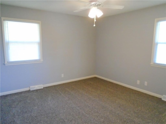 3020 N 81st St, Kansas City, KS 66109 - spare room with dark colored carpet, ceiling fan, and baseboards