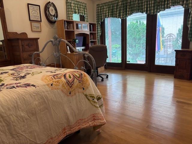 9803 W 121st St, Overland Park, KS 66213 - bedroom with wood finished floors and access to outside
