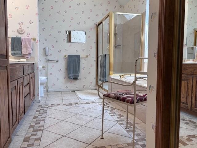 9803 W 121st St, Overland Park, KS 66213 - full bathroom with wallpapered walls, vanity, a shower stall, inlaid floor details, and tile patterned floors