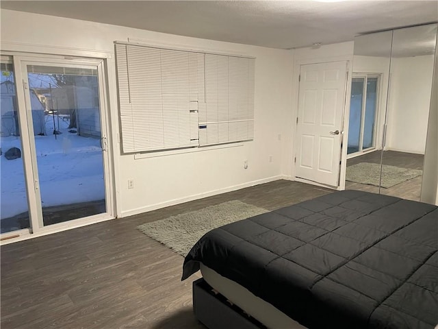 2911 S 26th St, Kansas City, KS 66106 - bedroom with access to exterior, dark wood-type flooring, baseboards, and a closet