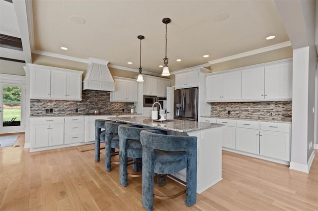 15825 Howe St, Overland Park, KS 66224 - kitchen featuring stainless steel refrigerator with ice dispenser, custom range hood, recessed lighting, white cabinetry, and a breakfast bar