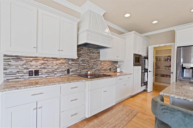 15825 Howe St, Overland Park, KS 66224 - kitchen featuring appliances with stainless steel finishes, premium range hood, white cabinets, recessed lighting, and decorative backsplash