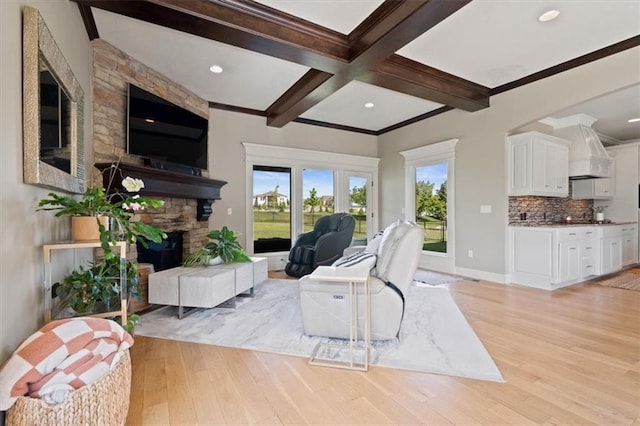 15825 Howe St, Overland Park, KS 66224 - living room with beamed ceiling, ornamental molding, light wood-style floors, a stone fireplace, and baseboards
