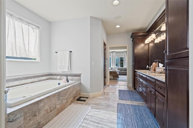 15825 Howe St, Overland Park, KS 66224 - ensuite bathroom featuring vanity, a garden tub, healthy amount of natural light, baseboards, and recessed lighting