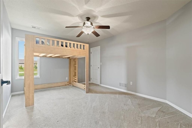 15825 Howe St, Overland Park, KS 66224 - unfurnished bedroom with carpet, baseboards, a ceiling fan, and a textured ceiling