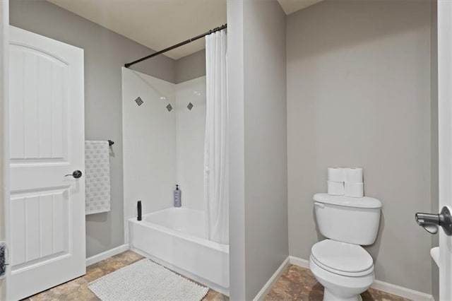 15825 Howe St, Overland Park, KS 66224 - full bathroom featuring shower / bath combo, toilet, baseboards, and stone finish floors