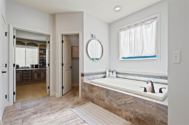 15825 Howe St, Overland Park, KS 66224 - bathroom with plenty of natural light, a bath, vanity, and a spacious closet
