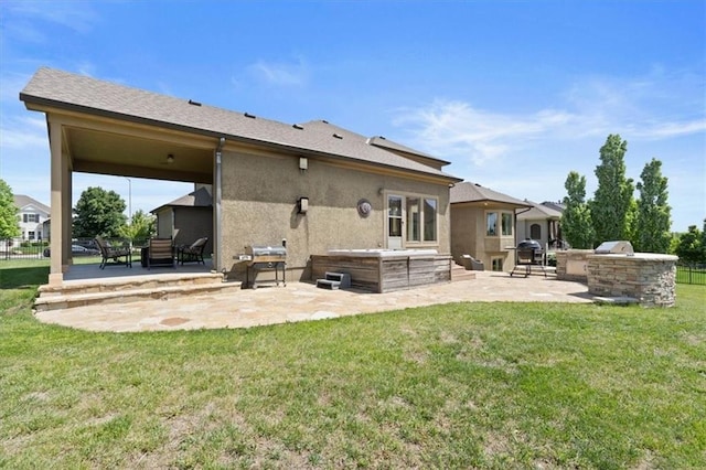 15825 Howe St, Overland Park, KS 66224 - rear view of property with a patio, an outdoor kitchen, a lawn, and stucco siding