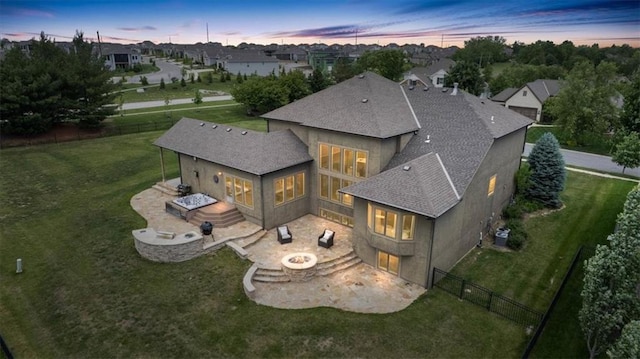 15825 Howe St, Overland Park, KS 66224 - back of property featuring a patio area, an outdoor fire pit, a shingled roof, and stucco siding