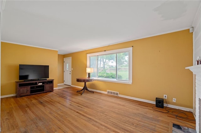 5347 Buena Vista St, Roeland Park, KS 66205 - unfurnished living room featuring ornamental molding, wood finished floors, baseboards, and a large fireplace