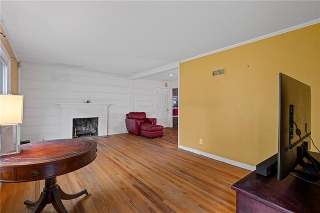 5347 Buena Vista St, Roeland Park, KS 66205 - living area with wood finished floors, baseboards, a fireplace, and ornamental molding
