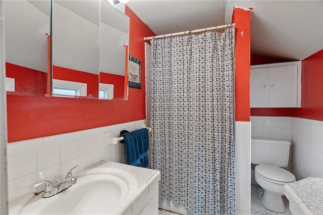 5347 Buena Vista St, Roeland Park, KS 66205 - full bathroom featuring tile walls, toilet, vanity, a wainscoted wall, and vaulted ceiling