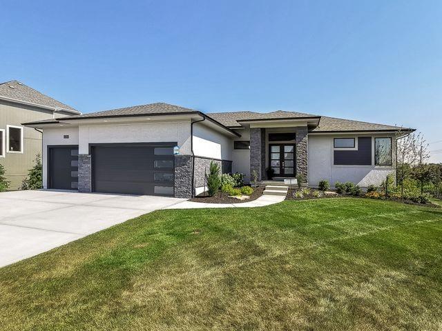 5907 N Lucerne Ave, Kansas City, MO 64151 - prairie-style house with an attached garage, concrete driveway, a front lawn, french doors, and stone siding