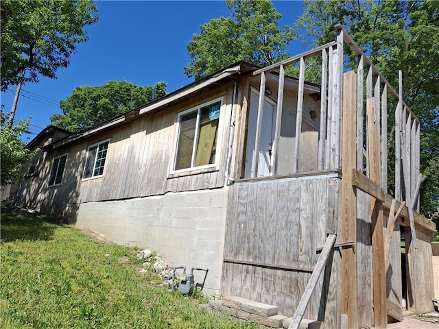 view of property exterior with a lawn