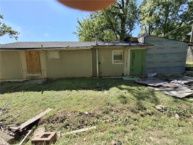 rear view of house with a yard