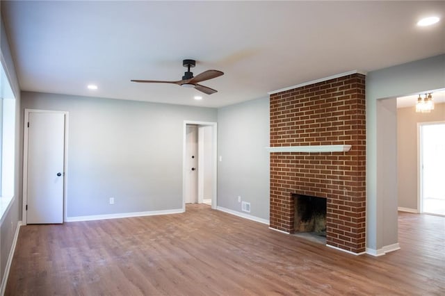 205 55th Ter, Kansas City, MO 64118 - unfurnished living room featuring a ceiling fan, wood finished floors, a fireplace, baseboards, and recessed lighting