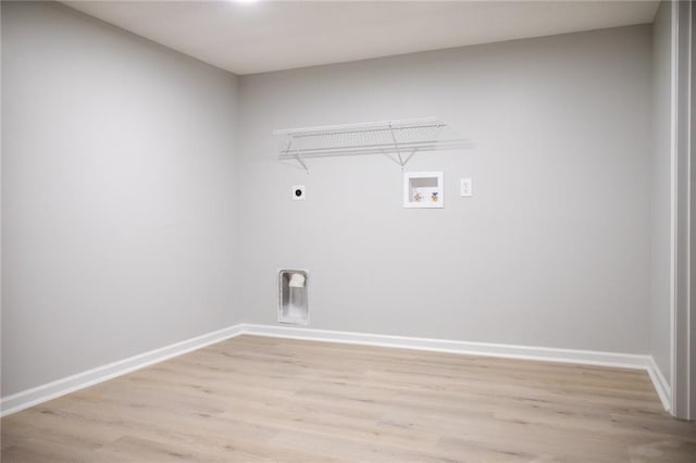 205 55th Ter, Kansas City, MO 64118 - laundry room with hookup for an electric dryer, hookup for a washing machine, light wood-style flooring, and baseboards