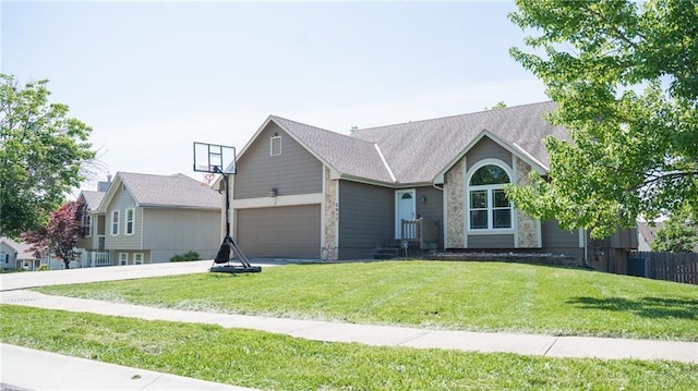 ranch-style house with stone siding, a front yard, driveway, an attached garage, and a shingled roof