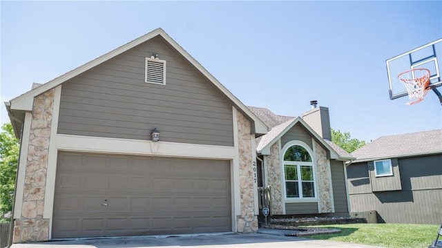 view of front of property with stone siding, a chimney, and driveway