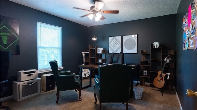 office space with a ceiling fan, carpet floors, a textured ceiling, and baseboards