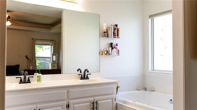 full bathroom featuring a bath, double vanity, and ceiling fan