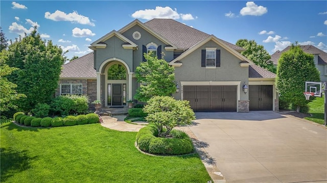 4502 Verona Ct, Riverside, MO 64150 - view of front facade with stucco siding, concrete driveway, a front yard, and a shingled roof